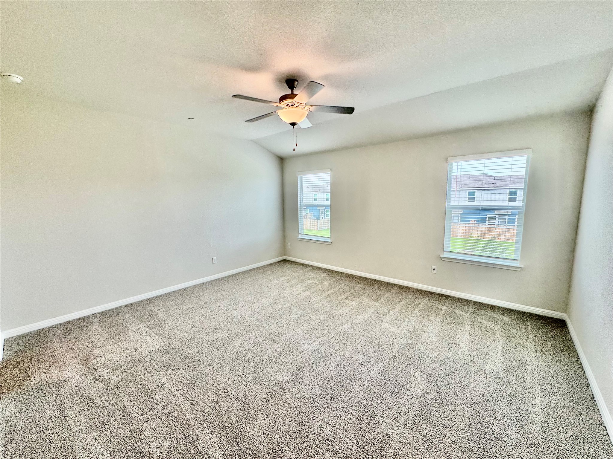 165 Calcite Road, Unit 3 Kyle, TX 78640 - Photo 3 of 17 an empty room with a window and a ceiling fan