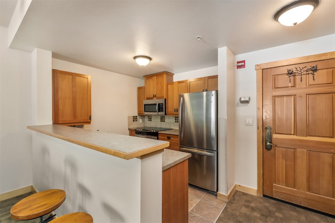 910 Copper Road, Unit 226 Copper Mountain, CO 80443 - Photo 11 of 27 a kitchen with stainless steel appliances granite countertop a refrigerator and a sink