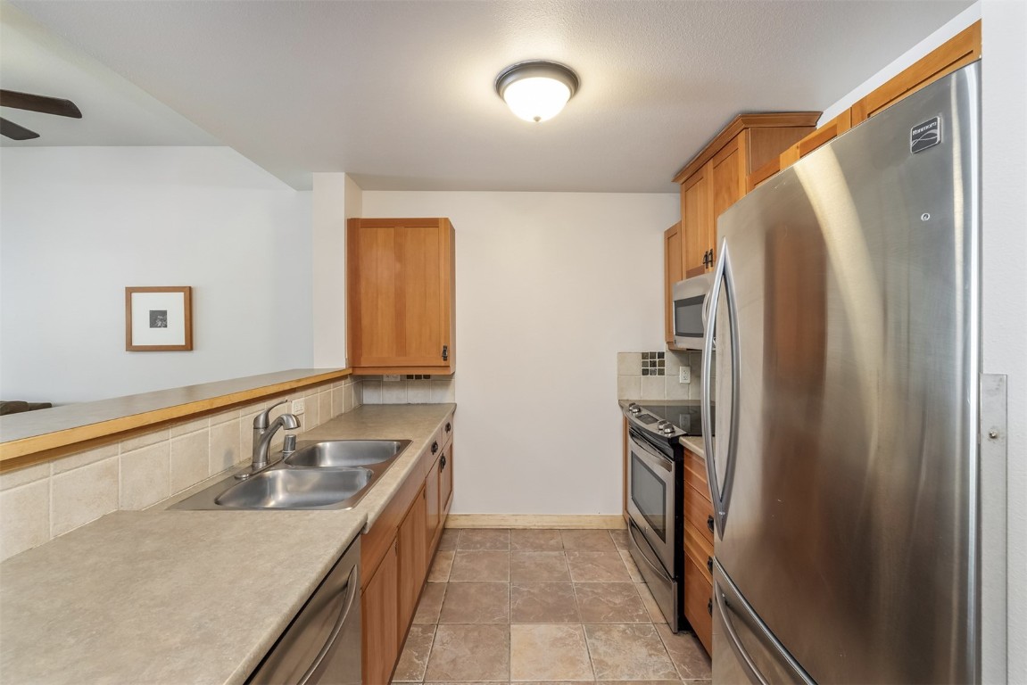 910 Copper Road, Unit 226 Copper Mountain, CO 80443 - Photo 6 of 27 a kitchen with stainless steel appliances granite countertop a refrigerator and a sink