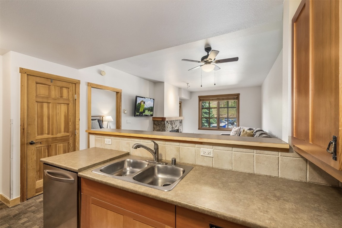 910 Copper Road, Unit 226 Copper Mountain, CO 80443 - Photo 7 of 27 a kitchen with a sink and a refrigerator