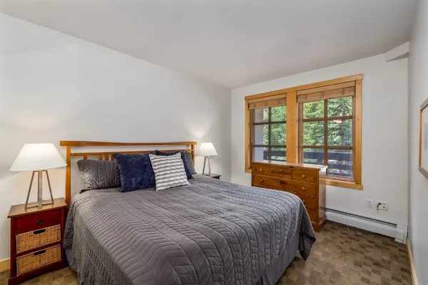a bedroom with a large bed and a large window