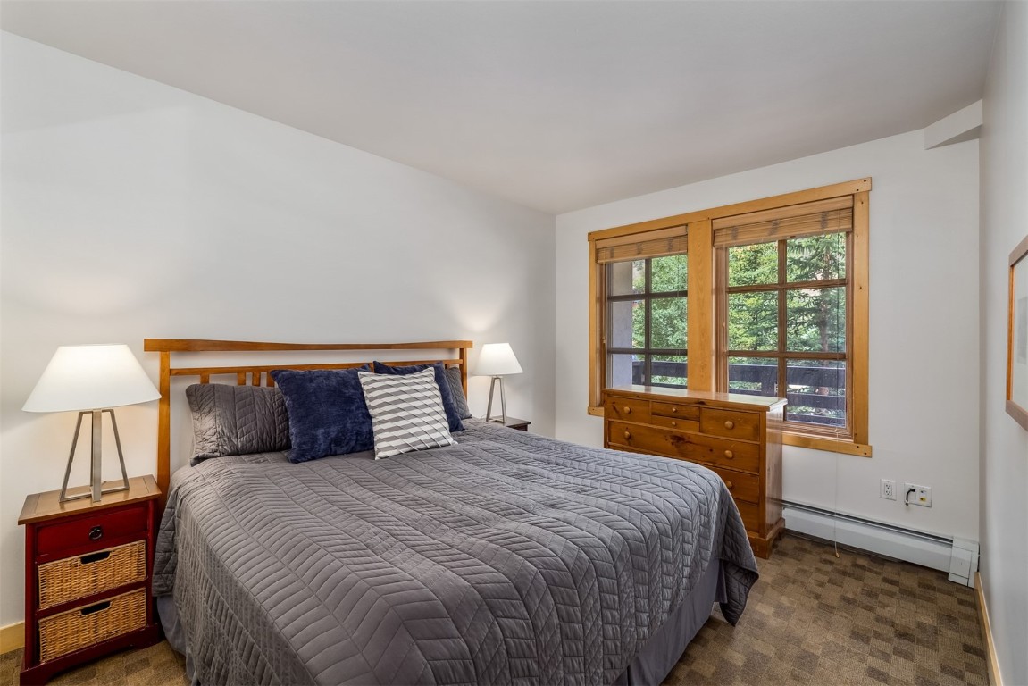 910 Copper Road, Unit 226 Copper Mountain, CO 80443 - Photo 8 of 27 a bedroom with a large bed and a large window