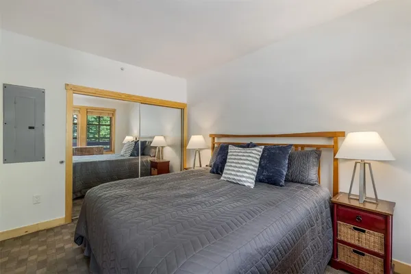 a bedroom with a bed and a lamp