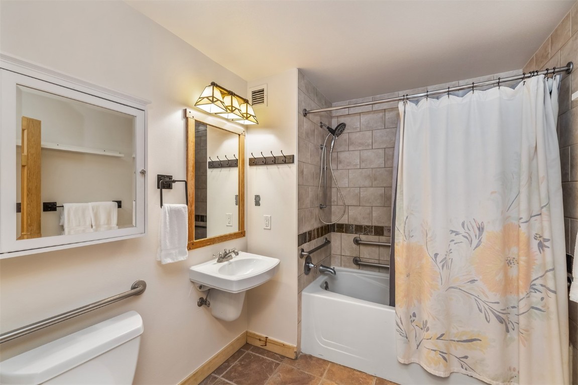 910 Copper Road, Unit 226 Copper Mountain, CO 80443 - Photo 10 of 27 a bathroom with a sink toilet a shower and a mirror