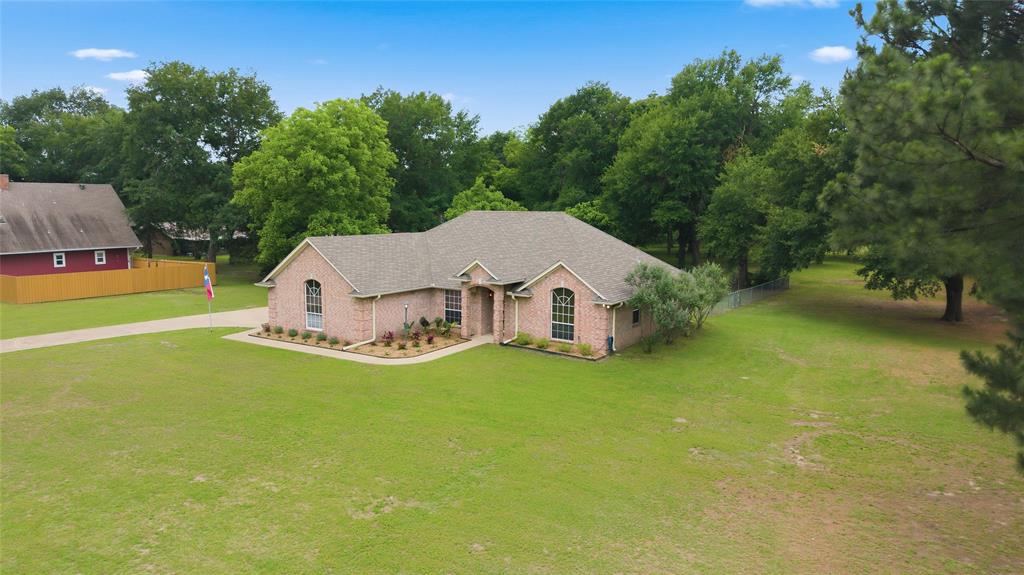2917 Harlow Road Commerce, TX 75428 - Photo 37 of 40 an aerial view of a house with swimming pool next to a big yard
