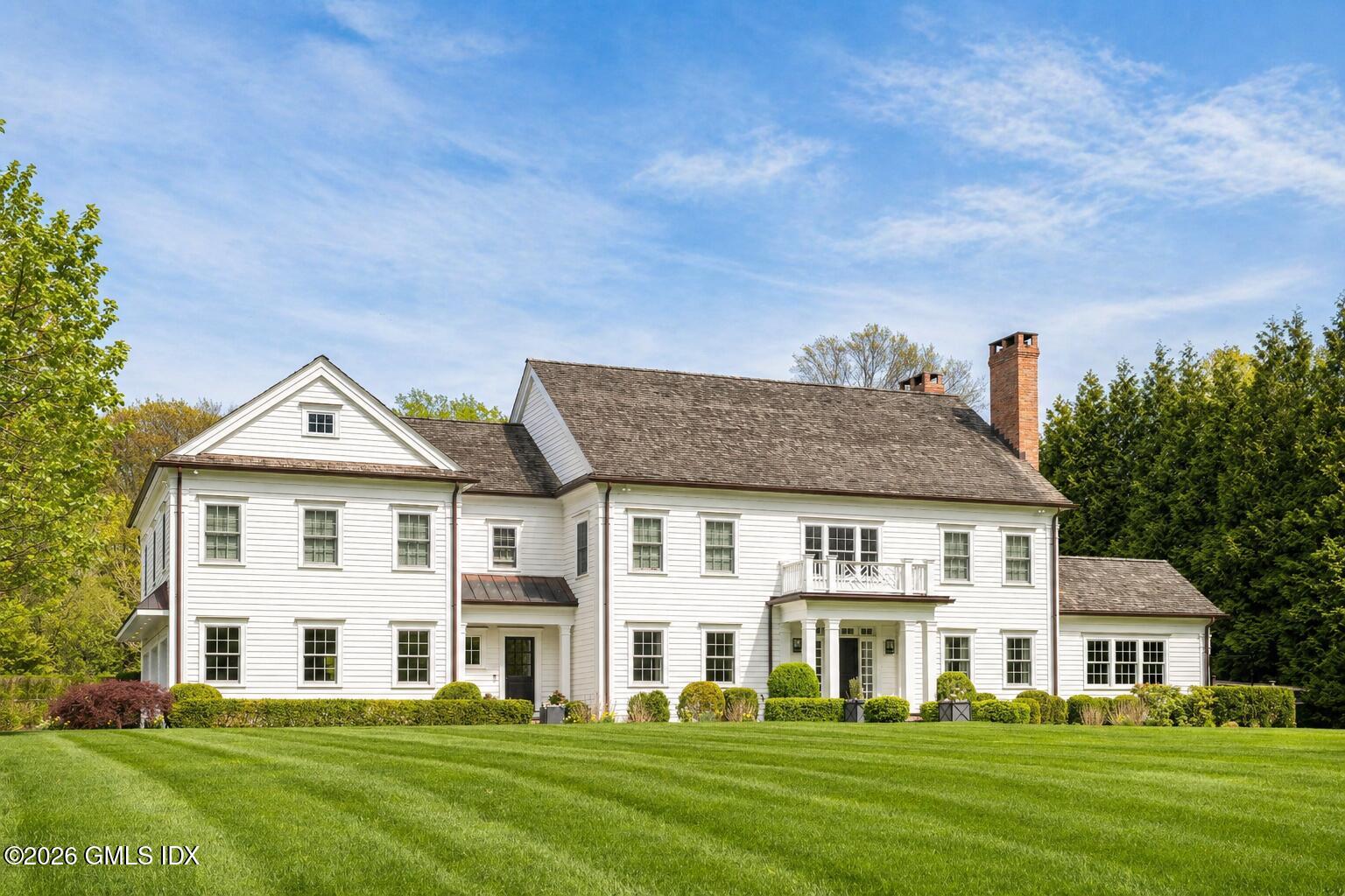 Undisclosed Address Darien, CT 06820 - Photo 1 of 1 a front view of a house with a garden
