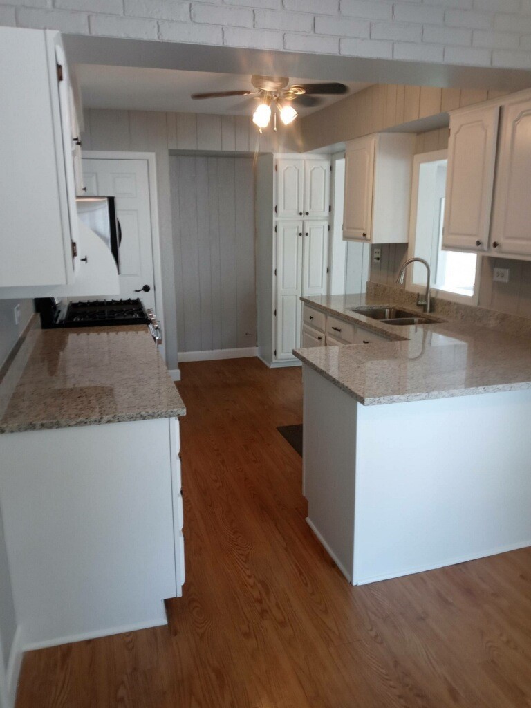S528 Finley Road Lombard, IL 60148 - Photo 9 of 28 a kitchen with granite countertop a stove and a sink