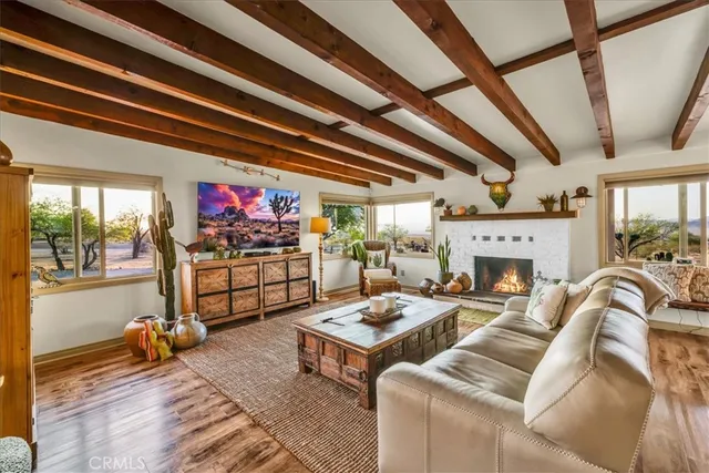 a kitchen with stainless steel appliances granite countertop a table chairs and a refrigerator