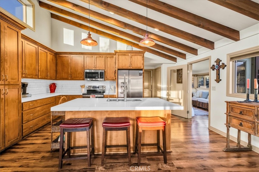 4565 Rock Corral Road Johnson Valley, CA 92285 - Photo 15 of 75 a kitchen with a table chairs stove and cabinets
