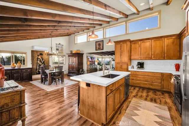 a view of a dining room with furniture a chandelier and wooden floor