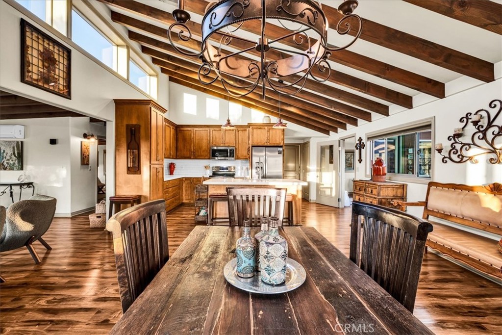4565 Rock Corral Road Johnson Valley, CA 92285 - Photo 23 of 75 a view of a dining room with furniture a chandelier and wooden floor