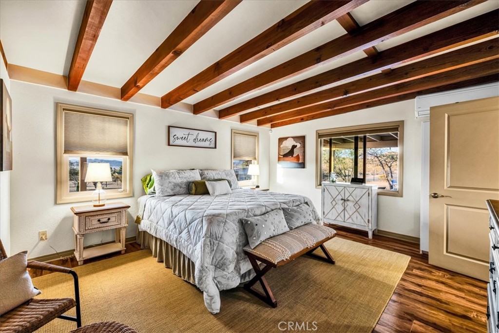 4565 Rock Corral Road Johnson Valley, CA 92285 - Photo 24 of 75 a spacious bedroom with a large bed and a chandelier