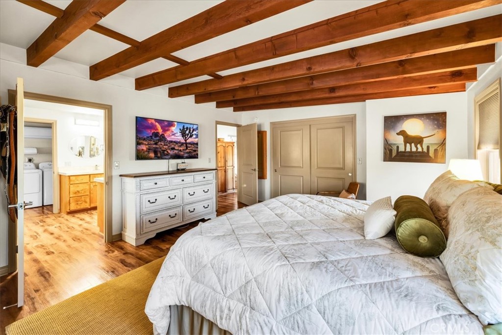 4565 Rock Corral Road Johnson Valley, CA 92285 - Photo 26 of 75 a bedroom with a bed and wooden floor