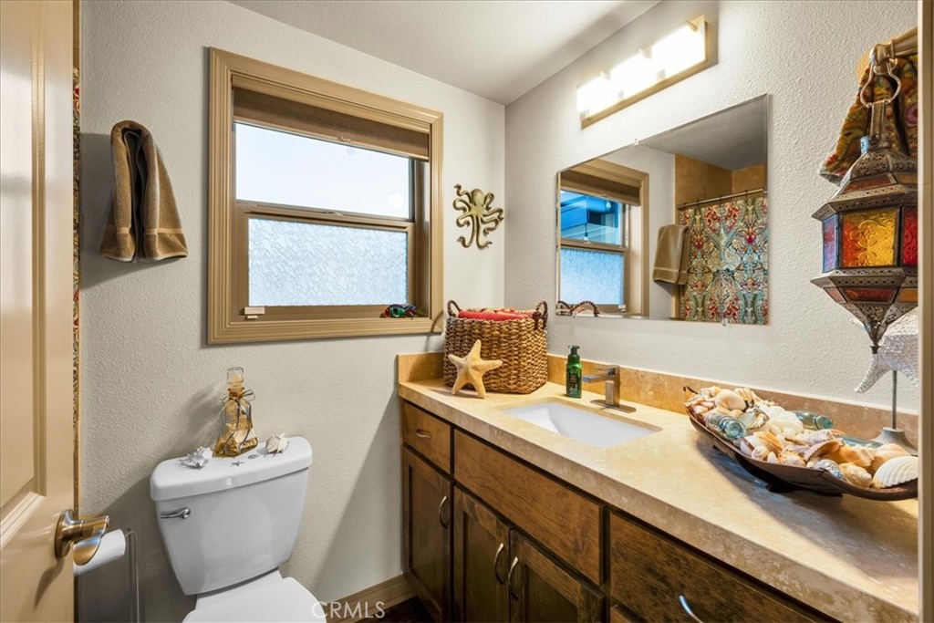 4565 Rock Corral Road Johnson Valley, CA 92285 - Photo 31 of 75 a bathroom with a toilet sink and mirror