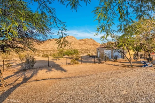 a view of a house with backyard porch and sitting area