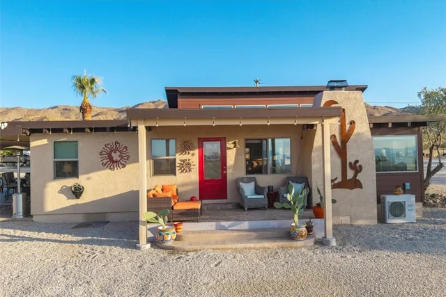 a living room with furniture a rug and a floor to ceiling window