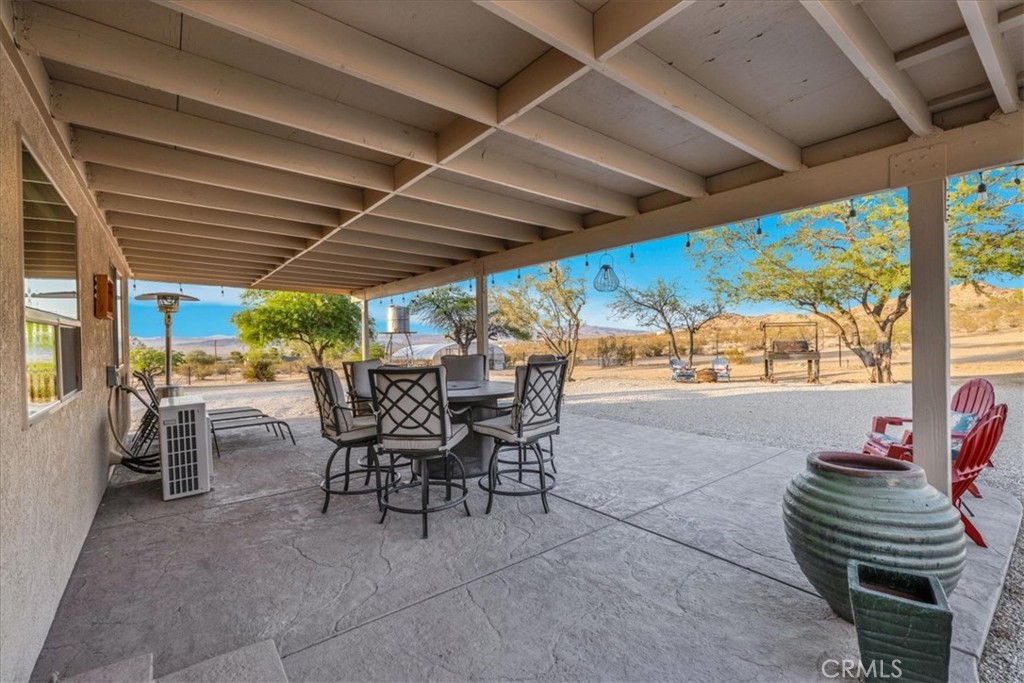 4565 Rock Corral Road Johnson Valley, CA 92285 - Photo 45 of 75 a view of a patio with table and chairs and potted plants