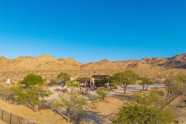 a view of a large building with mountains in the background