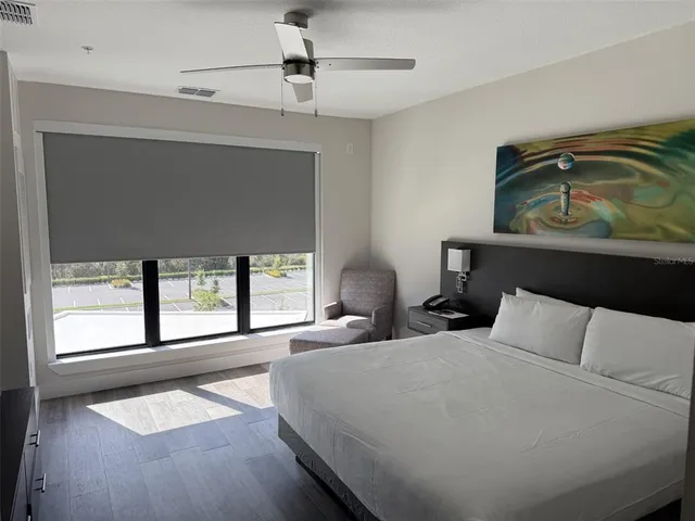 a bedroom with a large bed and a window