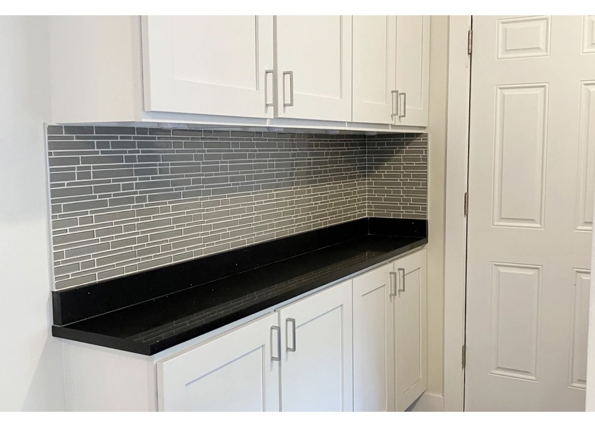 4218 North Clark Street, Unit 2 Chicago, IL 60613 - Photo 6 of 12 a view of kitchen with granite countertop white cabinets and black appliances