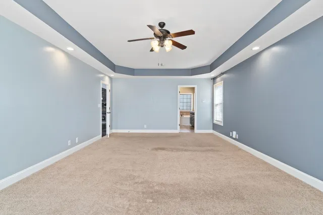 a bathroom with a granite countertop sink mirror and a bathtub