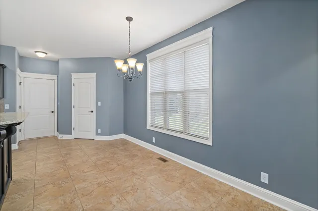 a large kitchen with a large island in the center and stainless steel appliances