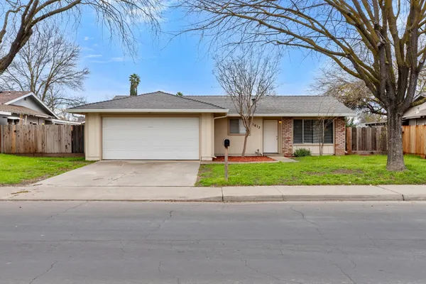 a front view of house with yard and green space