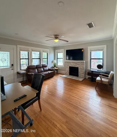 a view of a dining room with furniture window and wooden floor
