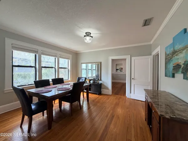 a view of a dining room with furniture window and wooden floor