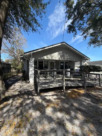 a view of a house with backyard porch and sitting area
