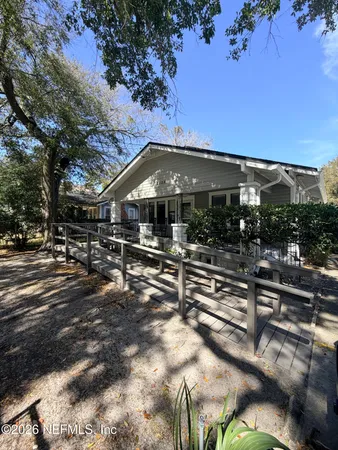 a view of a house with yard and sitting area