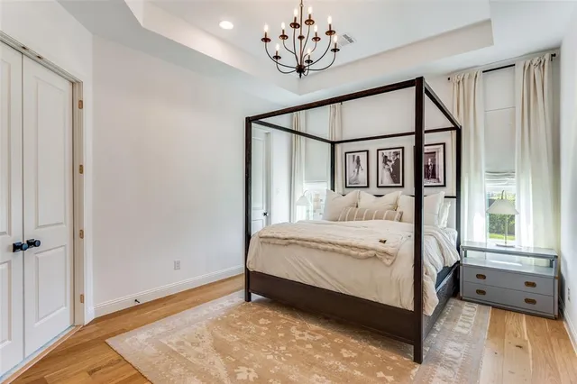 a large bed sitting in a bedroom next to a window