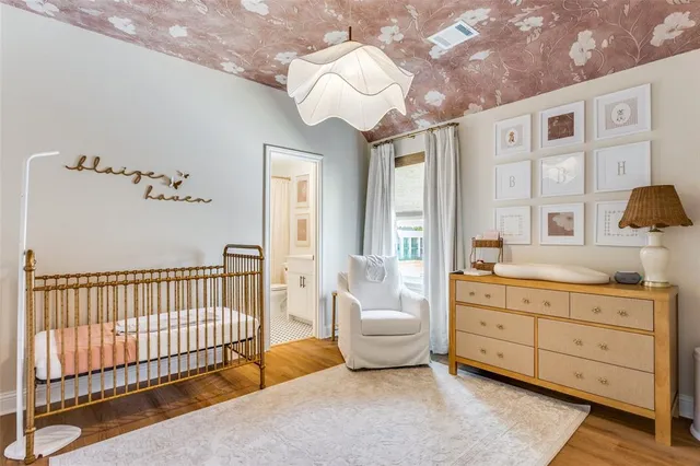 a spacious bedroom with a bed and a chandelier