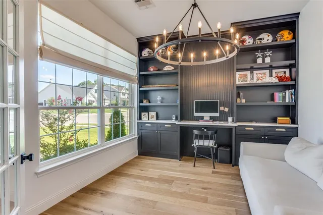 a kitchen with a large window appliances and cabinets