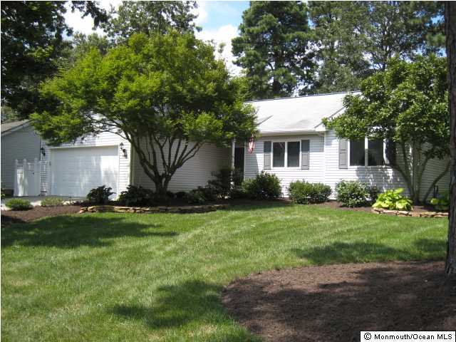 144 Yeoman Road Manahawkin, NJ 08050 - Photo 1 of 3 a front view of house with yard and green space