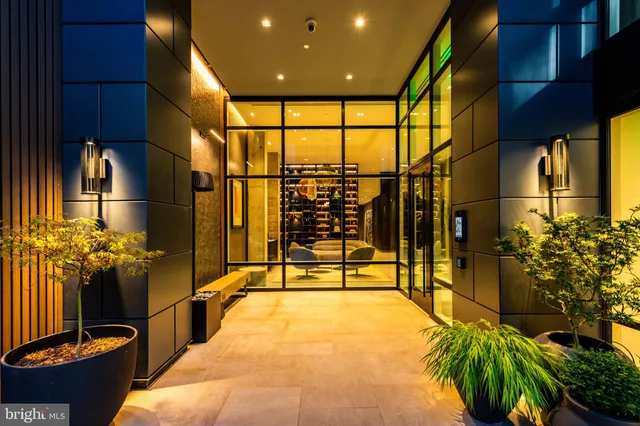 a lobby with a couch and potted plant