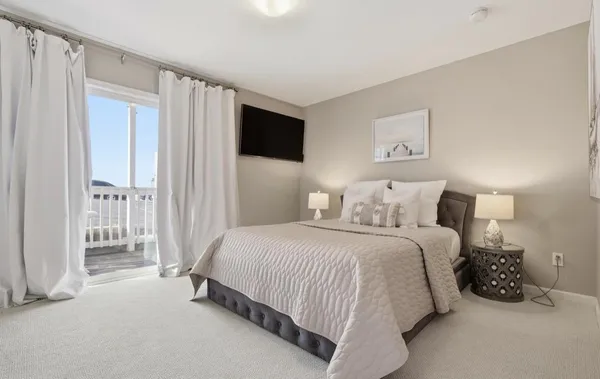 a spacious bedroom with a bed and a window