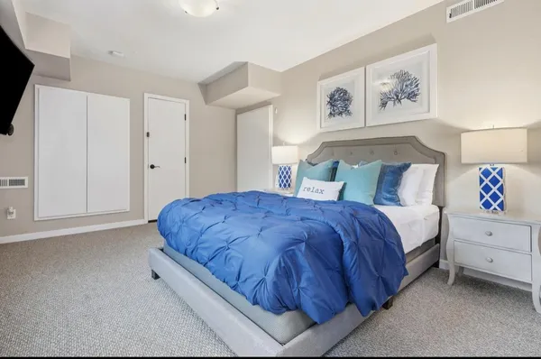 a spacious bedroom with a bed and a walk in closet