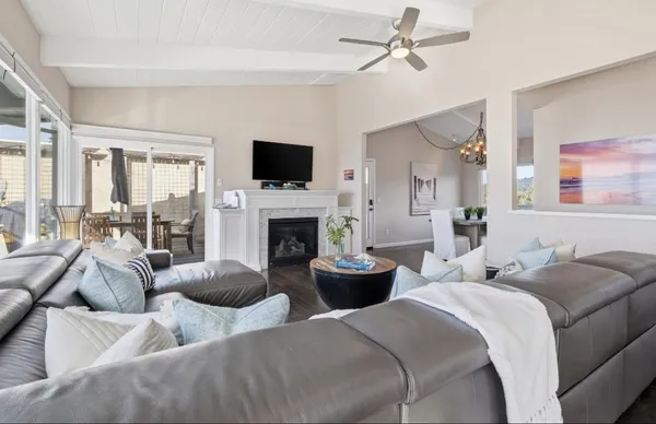 a living room with furniture a fireplace and a flat screen tv