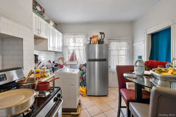 a view of a kitchen with a dining table and chairs