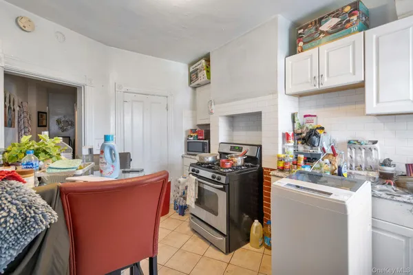a kitchen with stainless steel appliances a stove a sink dishwasher and cabinets with wooden floor