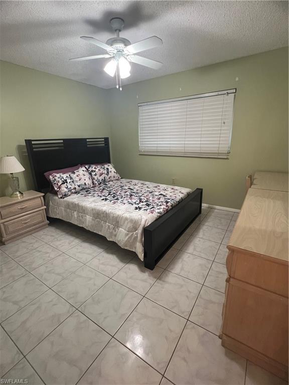 5419 Rattlesnake Hammock Road, Unit 306F Naples, FL 34113 - Photo 14 of 18 a bedroom with a bed and a window