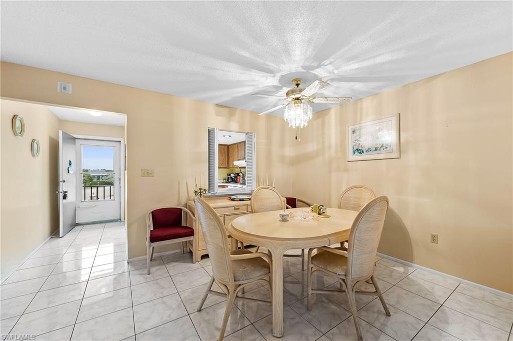 5419 Rattlesnake Hammock Road, Unit 306F Naples, FL 34113 - Photo 2 of 18 a view of a dining room with furniture and chandelier