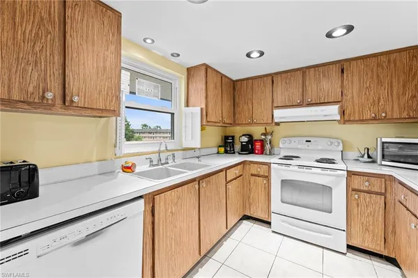 a kitchen with stainless steel appliances granite countertop a sink and cabinets
