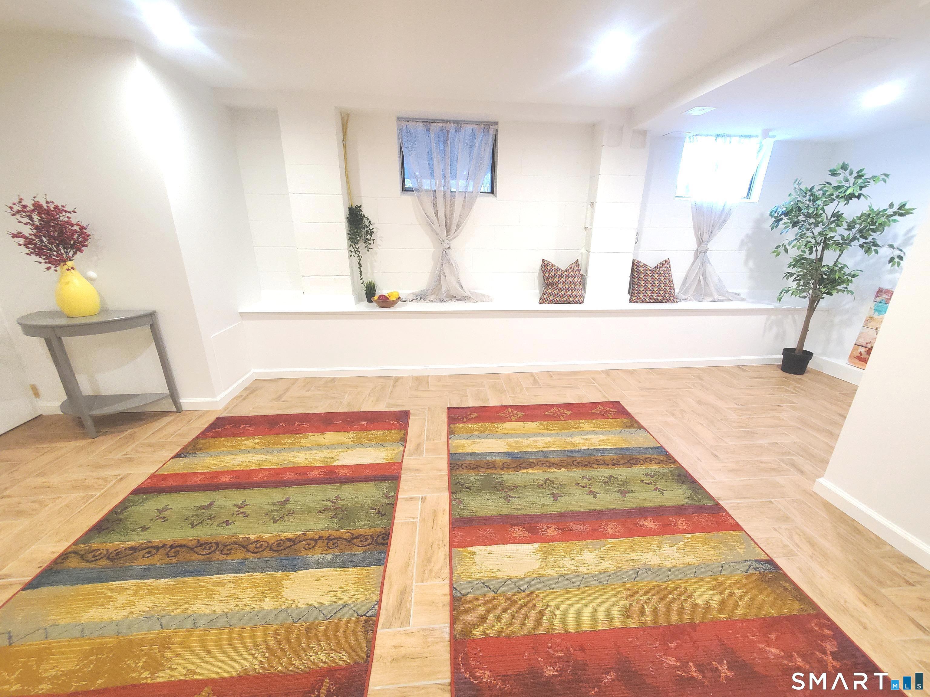 42 County Street Norwalk, CT 06851 - Photo 16 of 21 a living room with a rug and a table