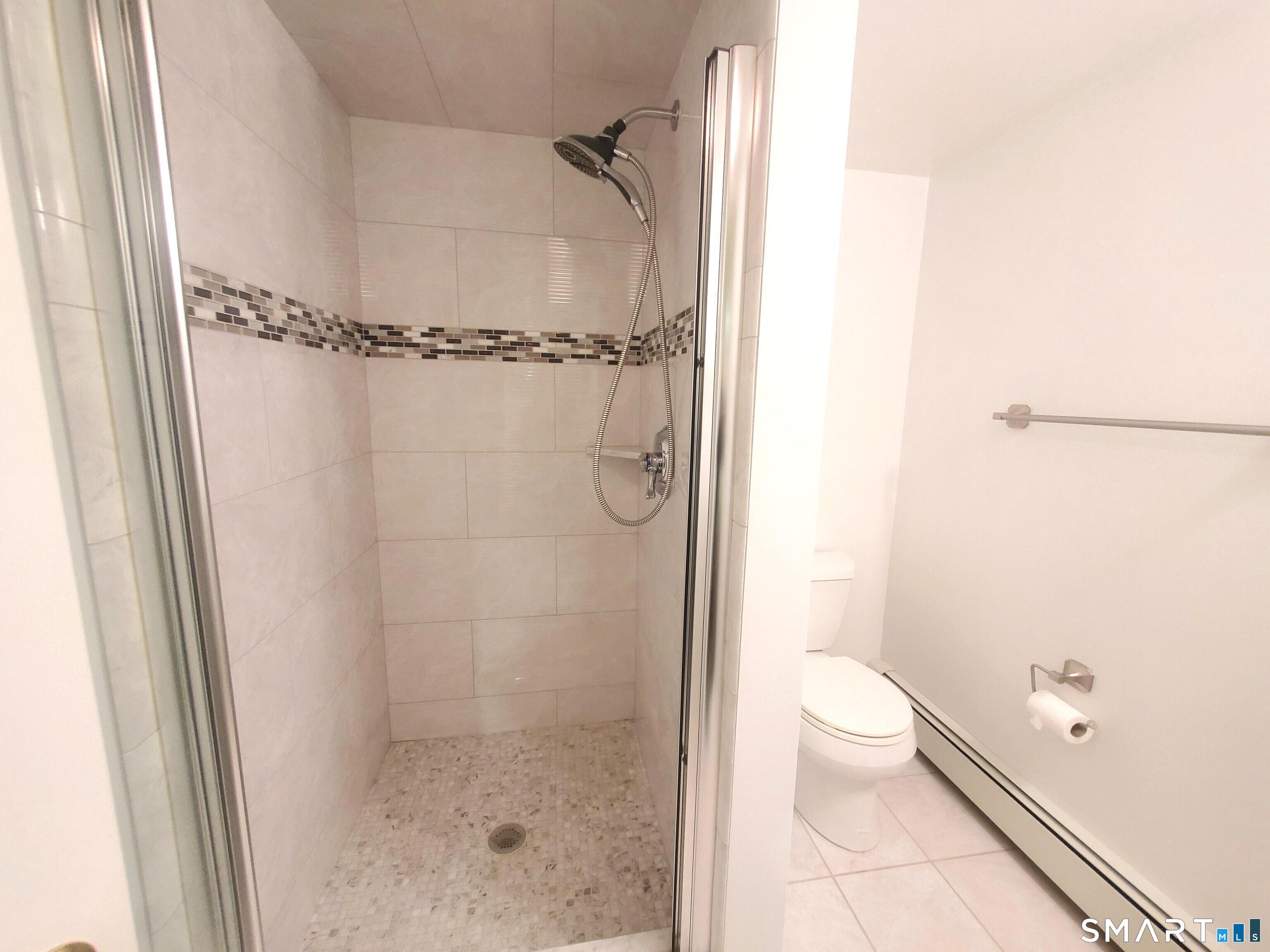 42 County Street Norwalk, CT 06851 - Photo 20 of 21 a bathroom with a granite countertop shower and a toilet