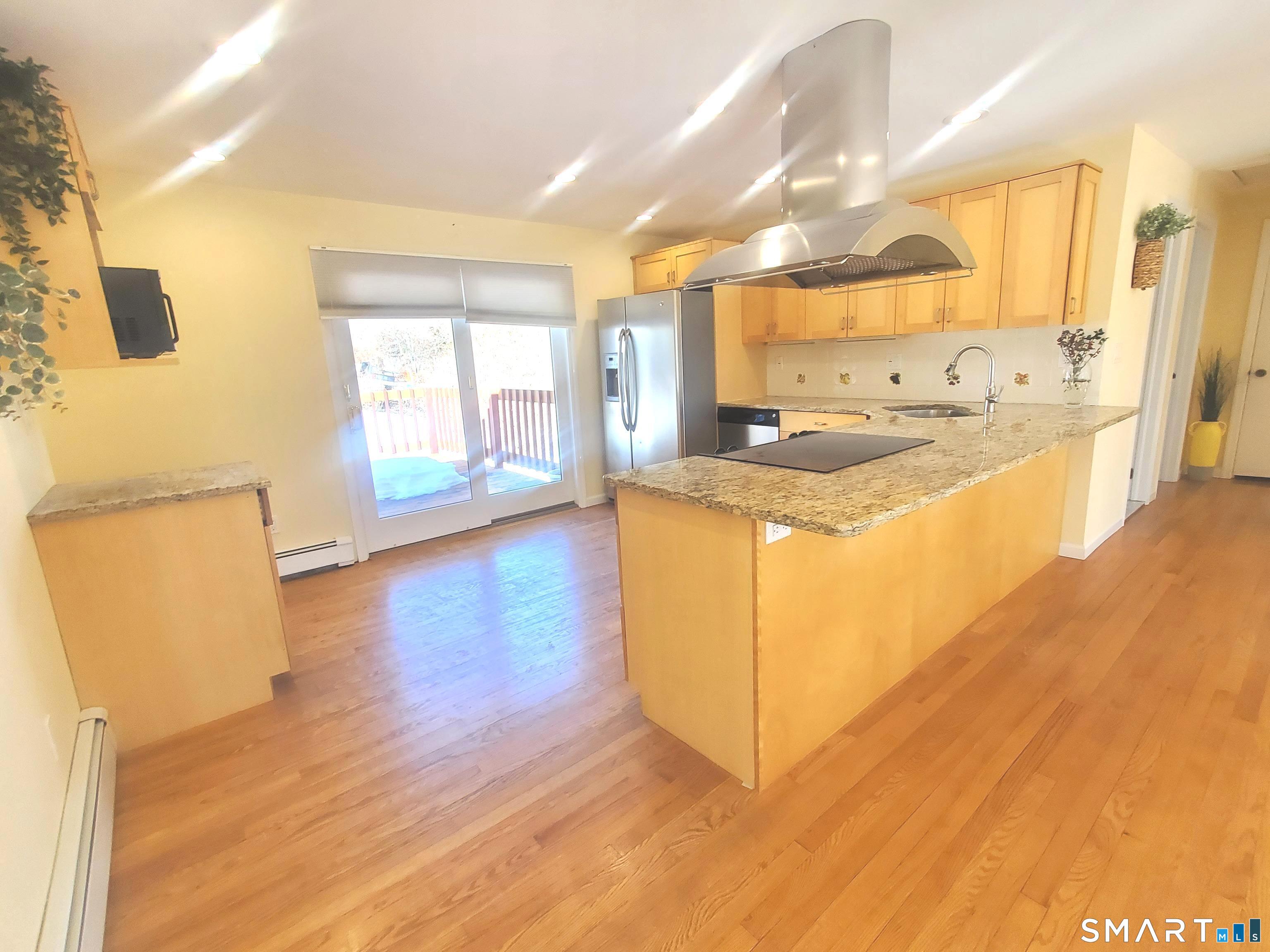 42 County Street Norwalk, CT 06851 - Photo 3 of 21 a view of a kitchen with wooden floor and a window