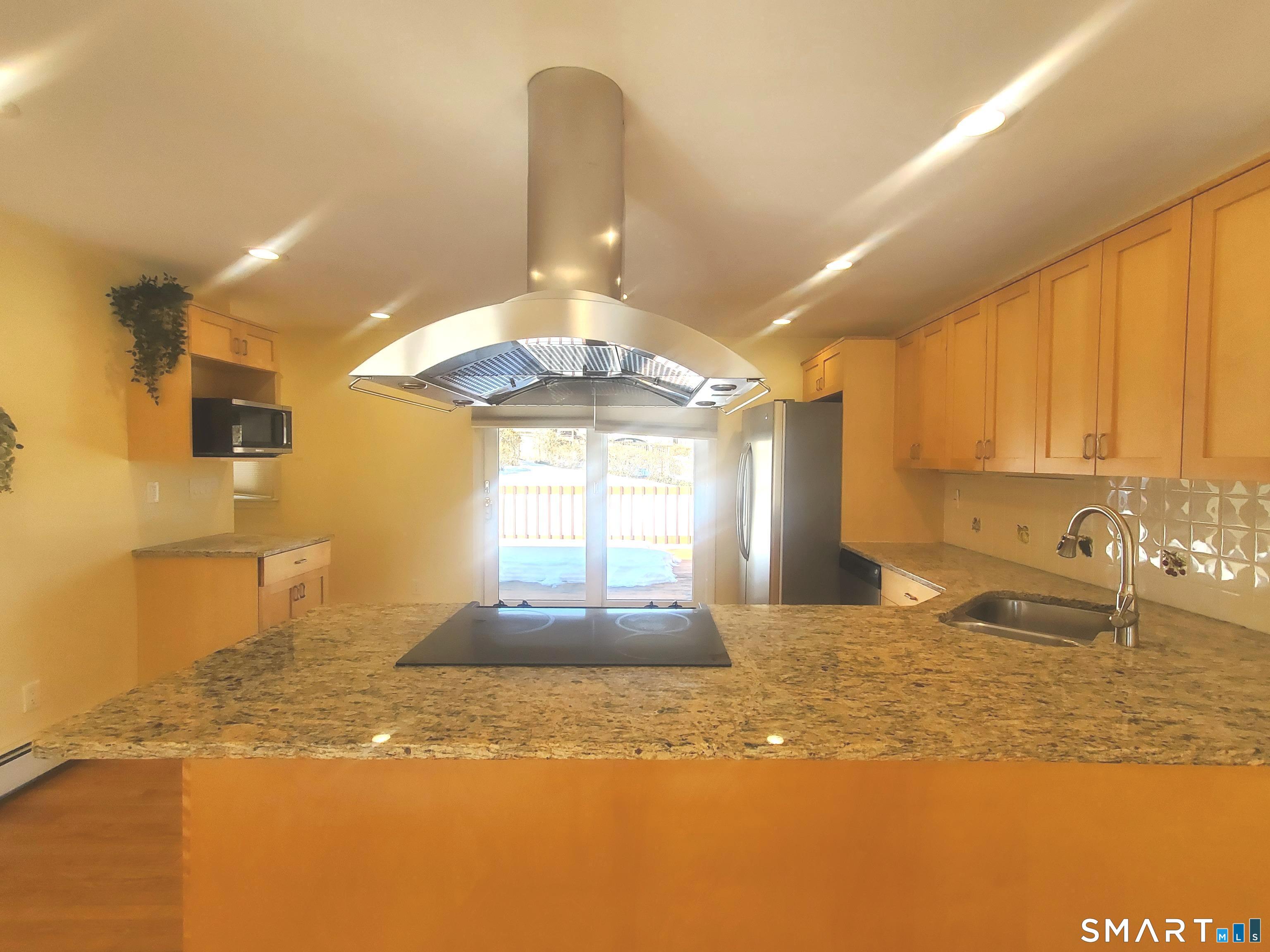 42 County Street Norwalk, CT 06851 - Photo 4 of 21 a view of a kitchen with granite countertop a sink and a granite counter top