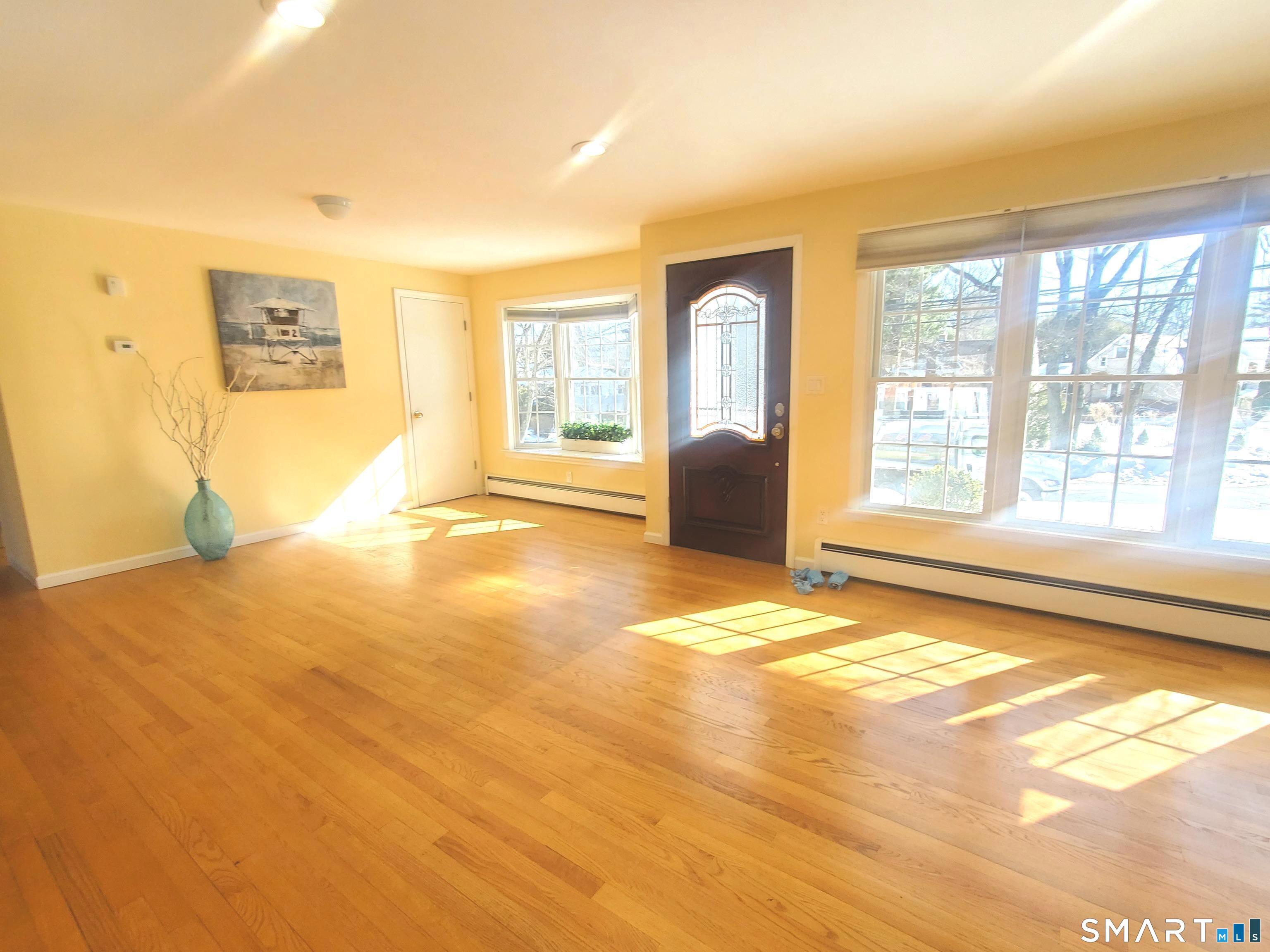 42 County Street Norwalk, CT 06851 - Photo 7 of 21 a view of an empty room with a window and a kitchen