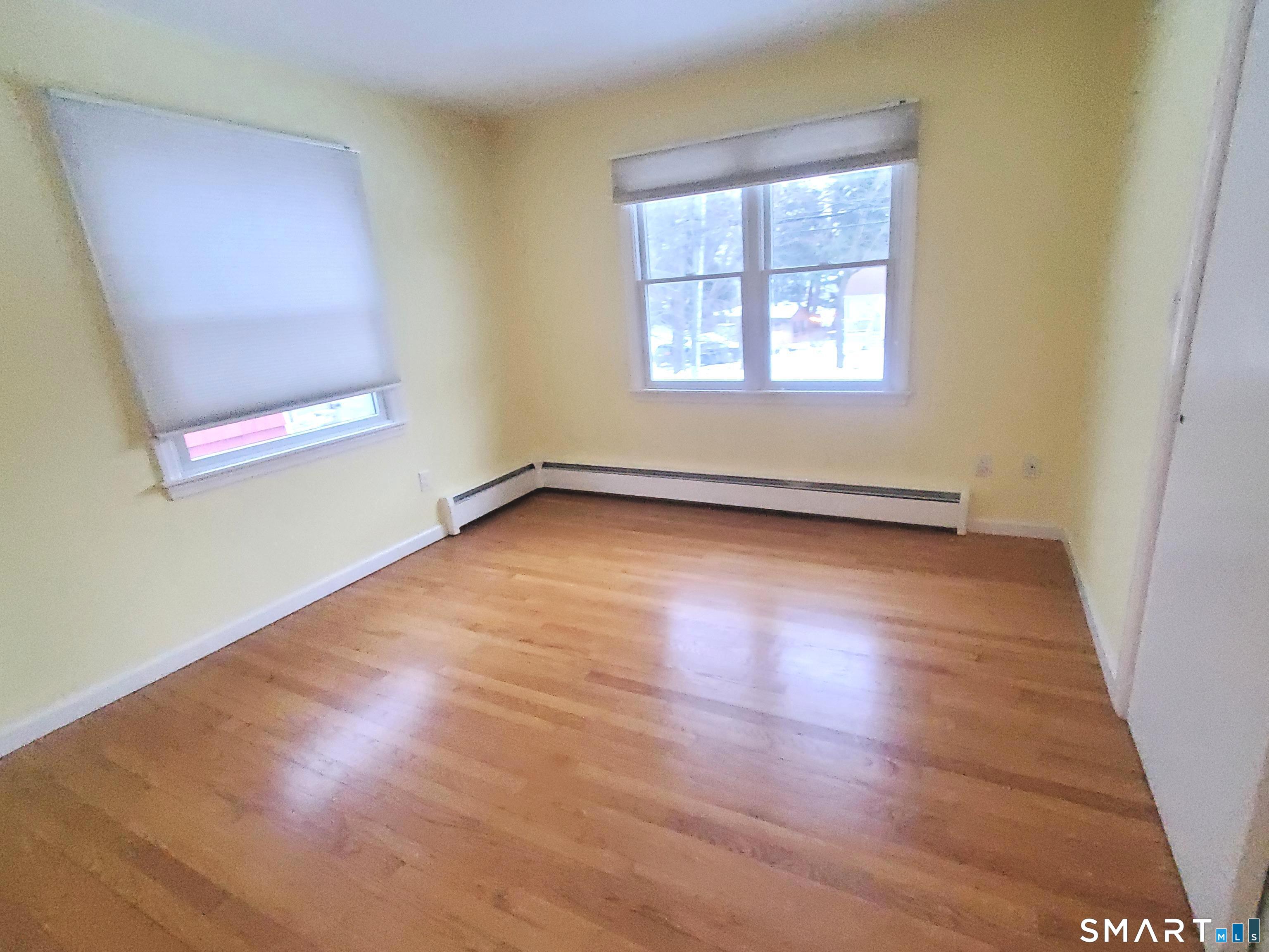 42 County Street Norwalk, CT 06851 - Photo 9 of 21 an empty room with wooden floor and windows